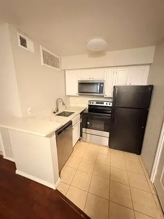 a kitchen with a refrigerator a sink and a stove