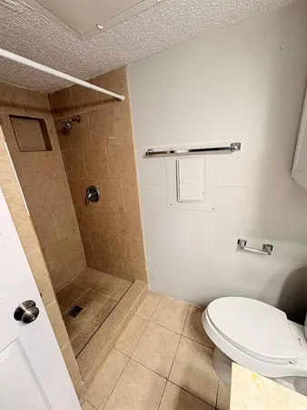 a bathroom with a toilet and a shower