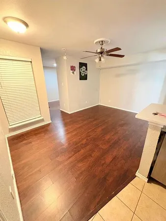 a view of a room with wooden floor