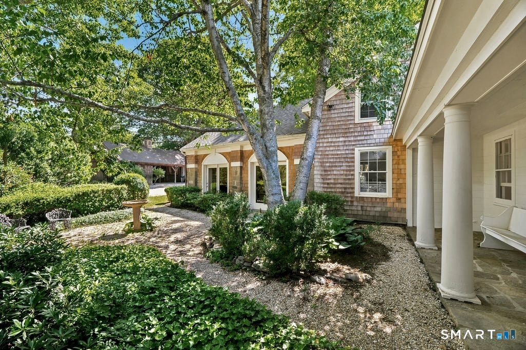 261-1 Grassy Hill Road Lyme, CT 06371 - Photo 39 of 40 Beautifullypositioned between the original home and the newer wing, the courtyard provides a picturesque setting surrounded by mature landscaping and timeless charm.