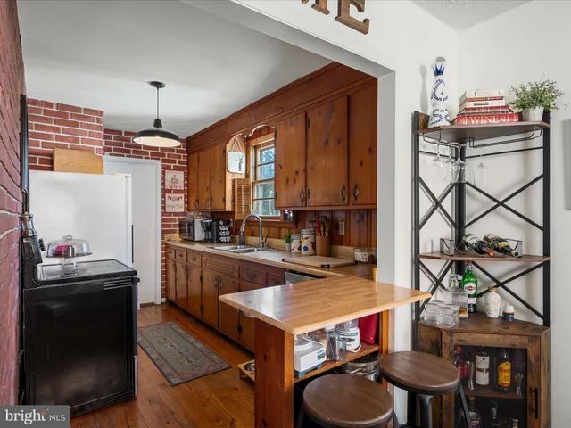 a kitchen with stainless steel appliances granite countertop a stove a refrigerator and a dining table