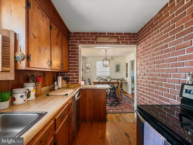 a kitchen with a sink and wooden cabinets