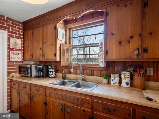 a kitchen with sink and large window