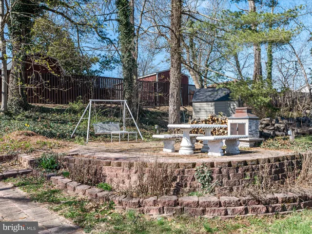 a view of a patio with table and chairs under an umbrella