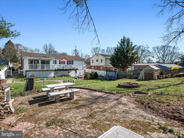 a front view of a house with a yard table and chairs
