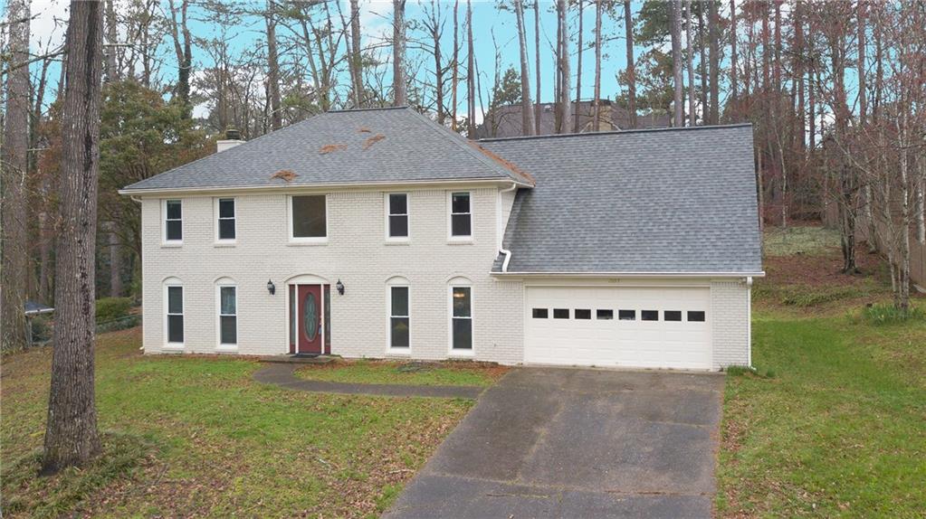 a view of a white house with a yard