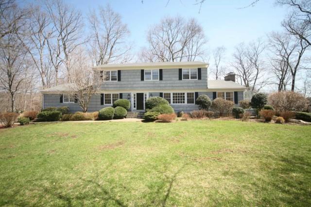 52 Indian Rock Road Stamford, CT 06903 - Photo 1 of 1 a front view of a house with a yard and trees