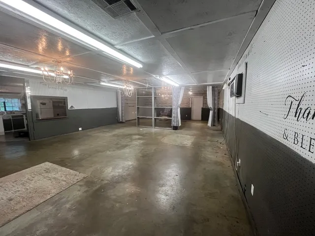 a view of a hall with wooden floors