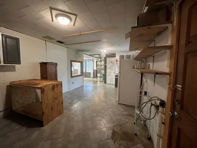a living room with furniture a flat screen tv and gym equipment