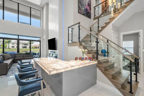 a kitchen with granite countertop a sink and a stove top oven with wooden floor
