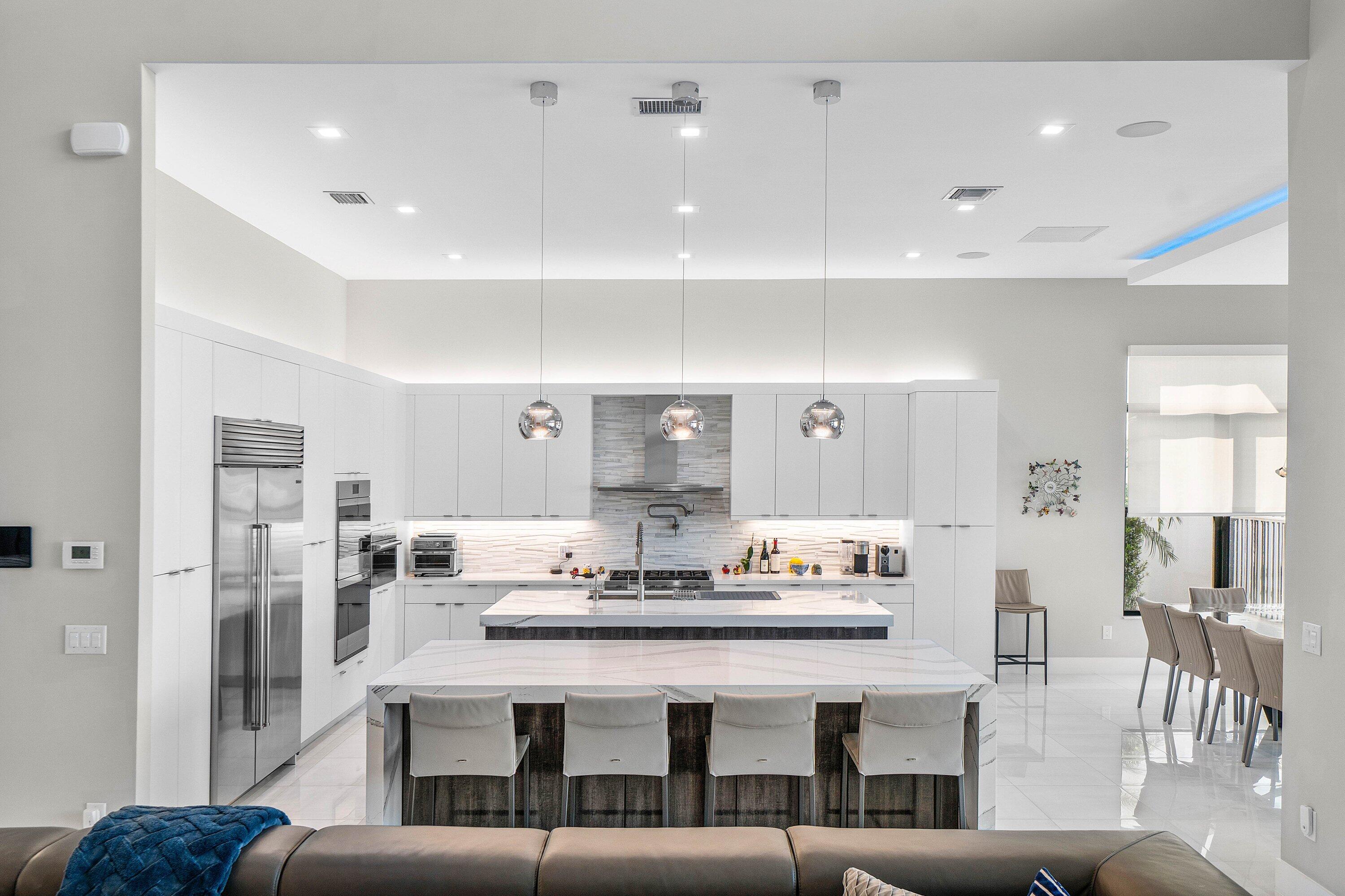 9657 Vescovato Way Boca Raton, FL 33496 - Photo 15 of 68 a living room with stainless steel appliances kitchen island granite countertop furniture and a view of kitchen