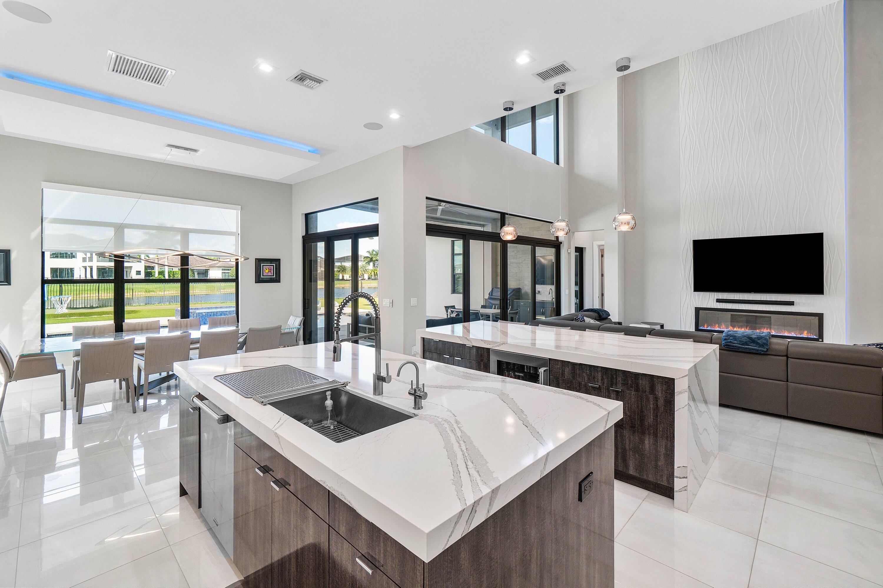 9657 Vescovato Way Boca Raton, FL 33496 - Photo 17 of 68 a kitchen with granite countertop a sink and a stove top oven with wooden floor