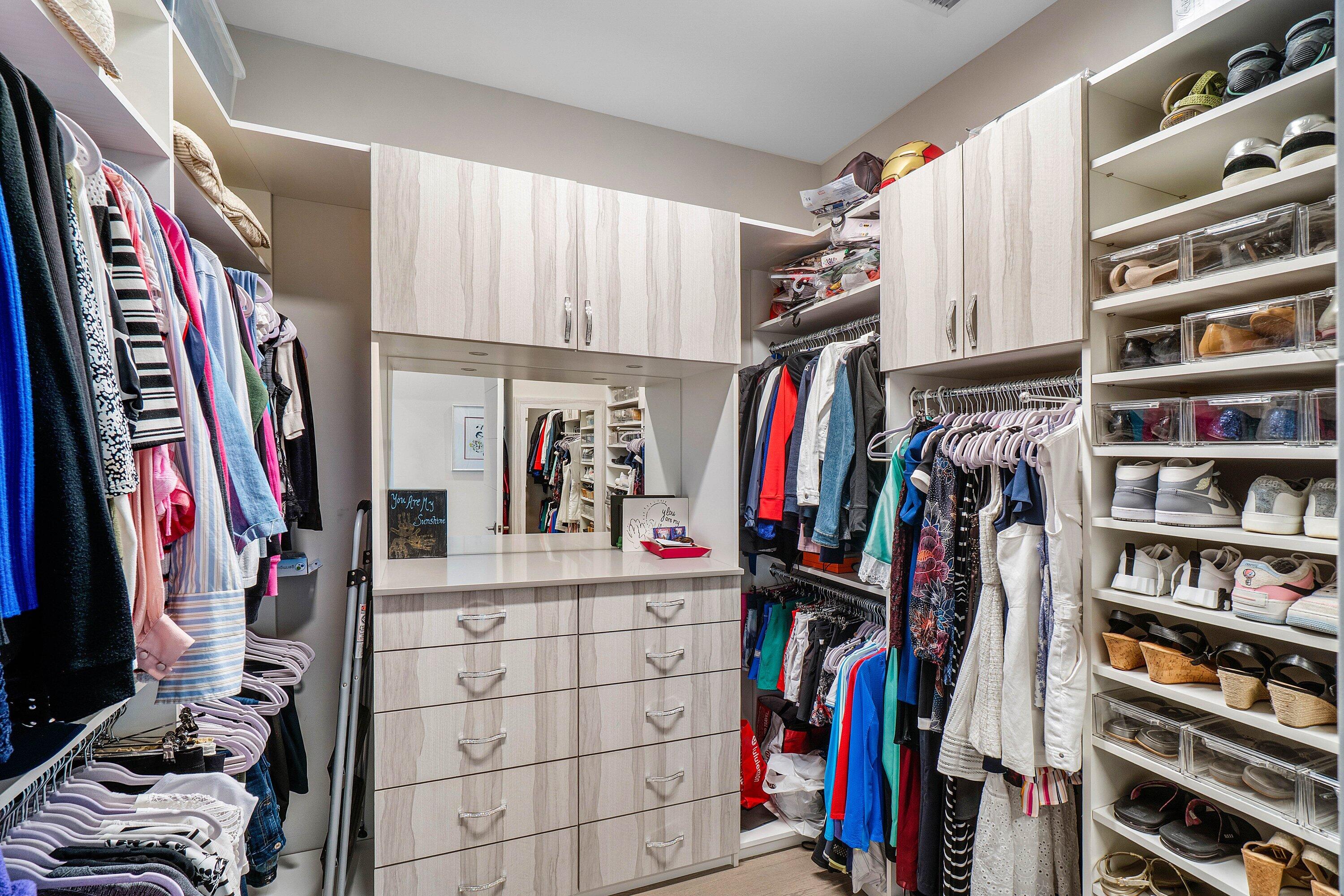 9657 Vescovato Way Boca Raton, FL 33496 - Photo 21 of 68 a view of walk in closet with clothes and shoes