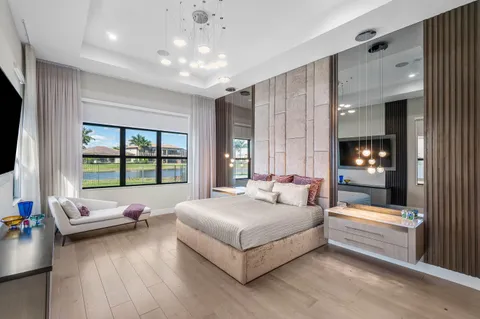 a bedroom with a bed and a chandelier