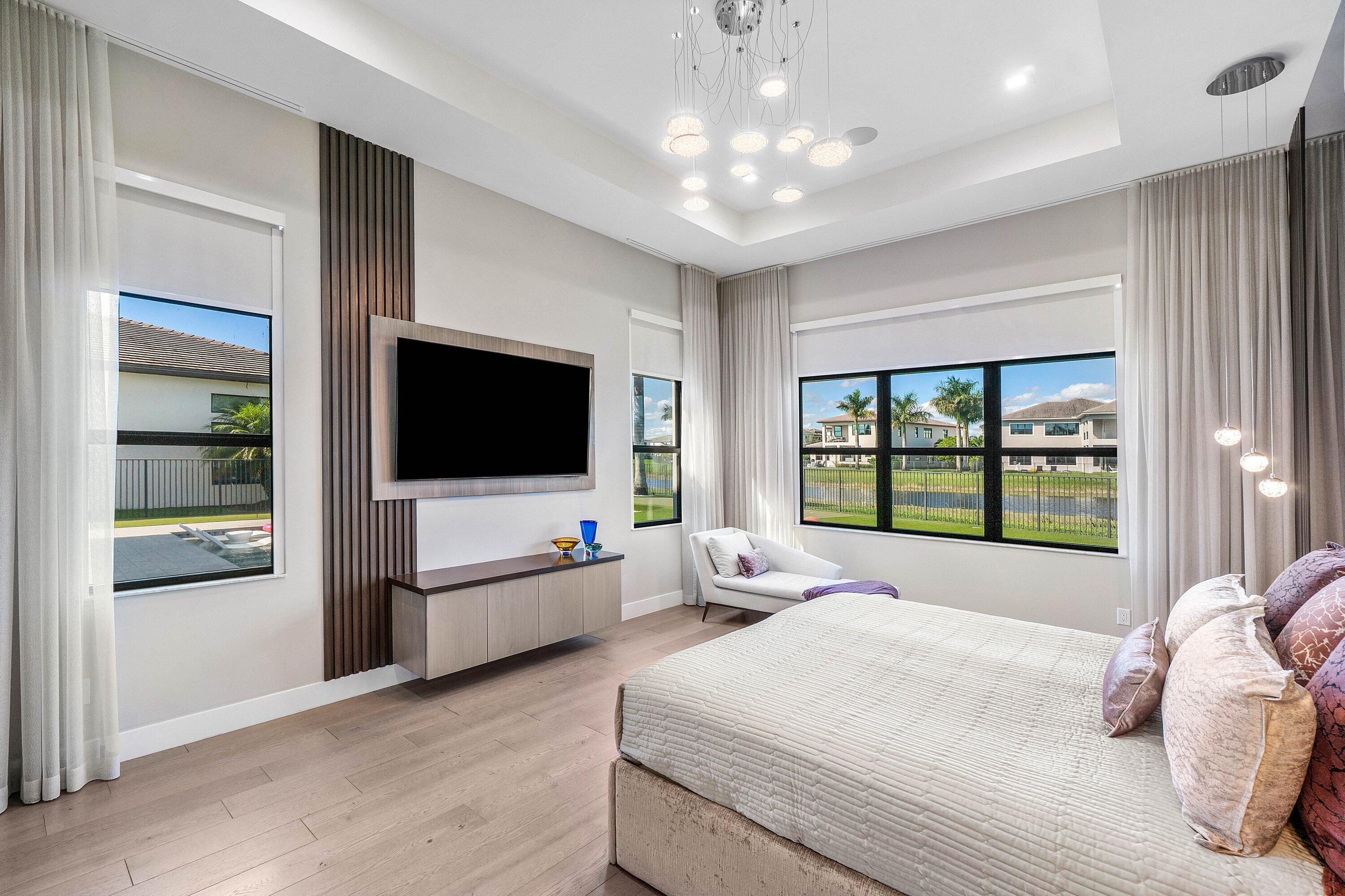 9657 Vescovato Way Boca Raton, FL 33496 - Photo 24 of 68 a bedroom with a bed and a flat screen tv