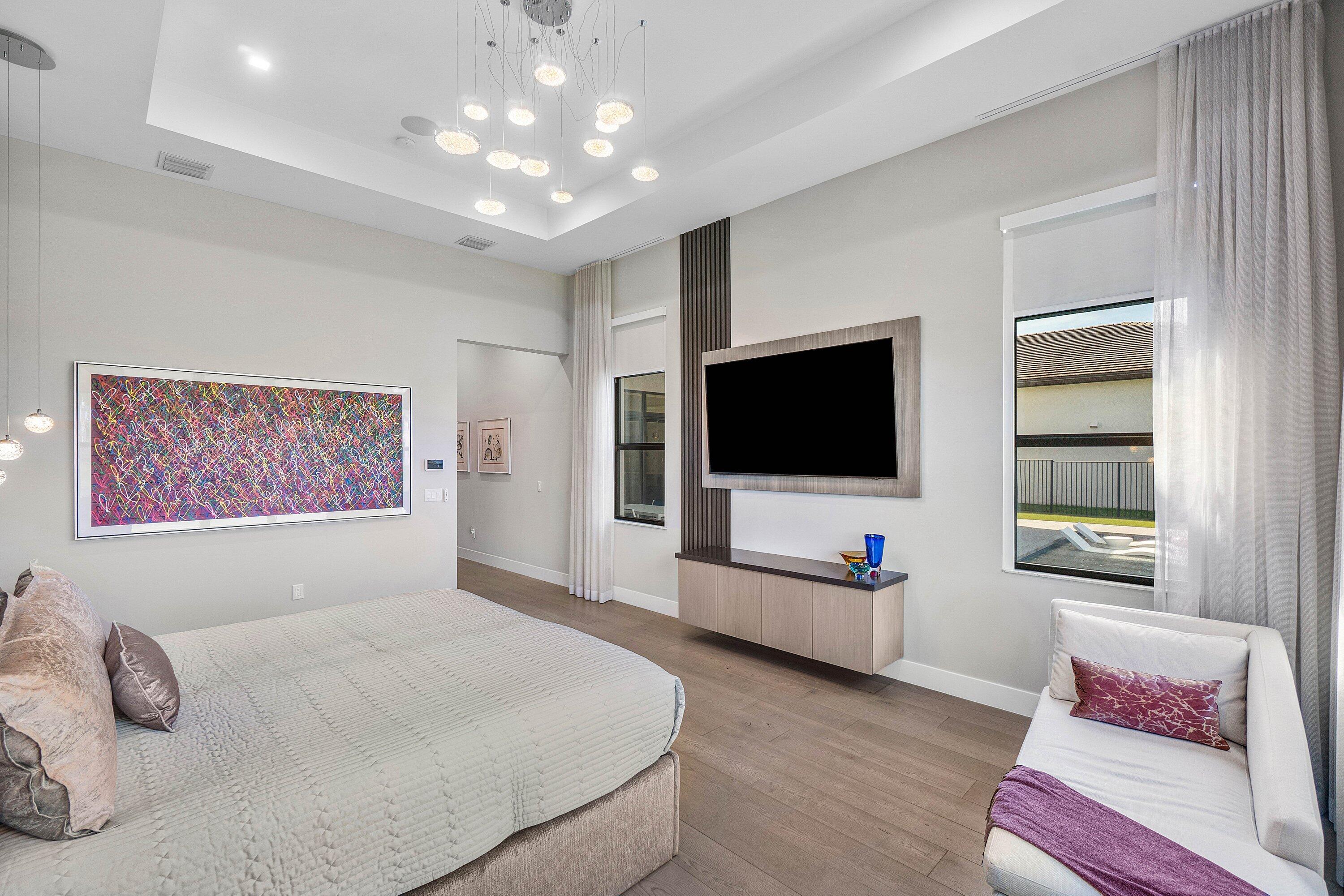 9657 Vescovato Way Boca Raton, FL 33496 - Photo 25 of 68 a bedroom with furniture and a flat screen tv