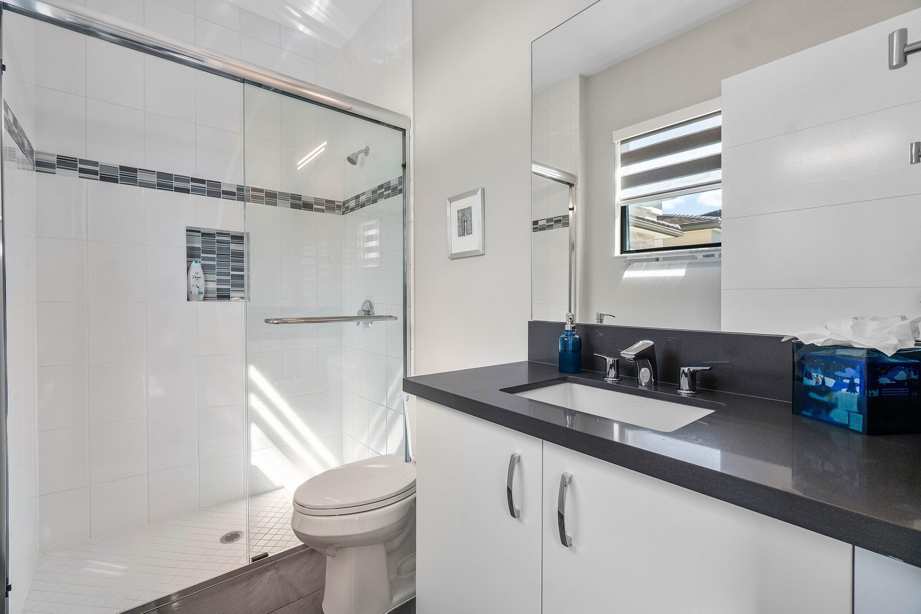 9657 Vescovato Way Boca Raton, FL 33496 - Photo 30 of 68 a bathroom with a granite countertop sink toilet and shower