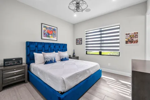 a bedroom with furniture and a floor to ceiling window