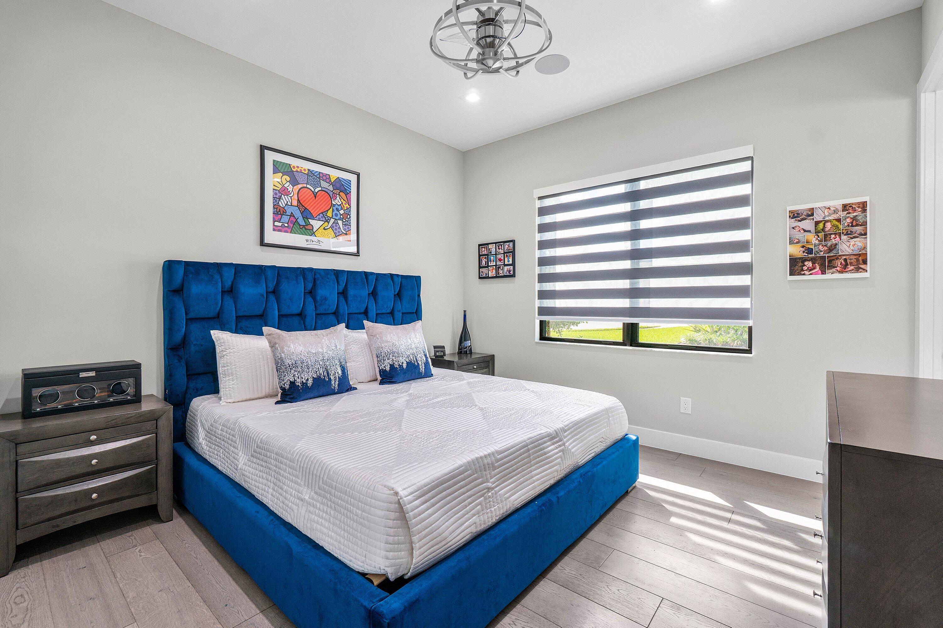 9657 Vescovato Way Boca Raton, FL 33496 - Photo 31 of 68 a bedroom with a bed and a chandelier