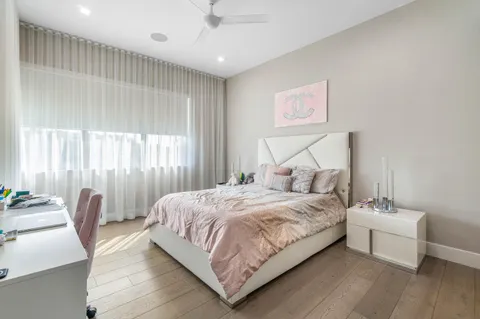 a living room with furniture a flat screen tv and a large window