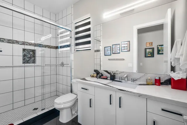 a view of a dining room and livingroom with furniture wooden floor a rug a potted plant and a chandelier