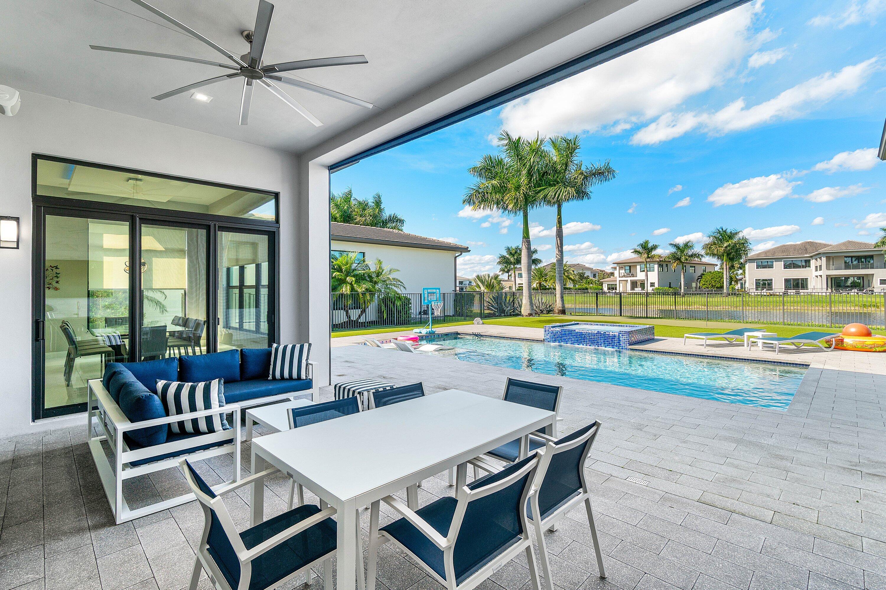 9657 Vescovato Way Boca Raton, FL 33496 - Photo 51 of 68 a view of a dining room with furniture window and wooden floor