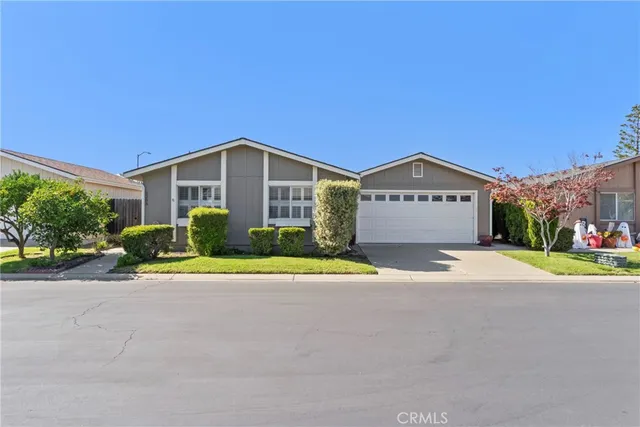 a front view of a house with a yard and a garage