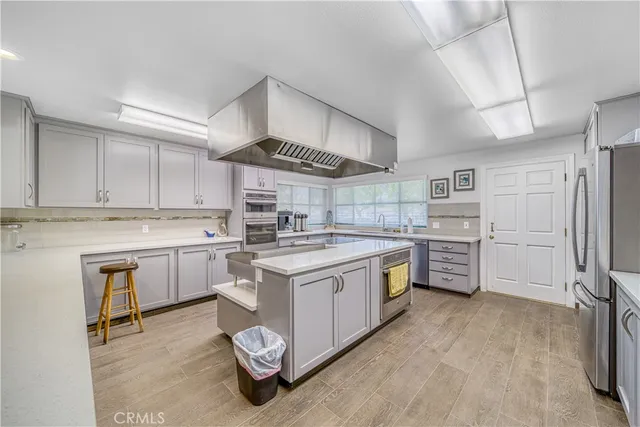 a kitchen with a stove sink and cabinets