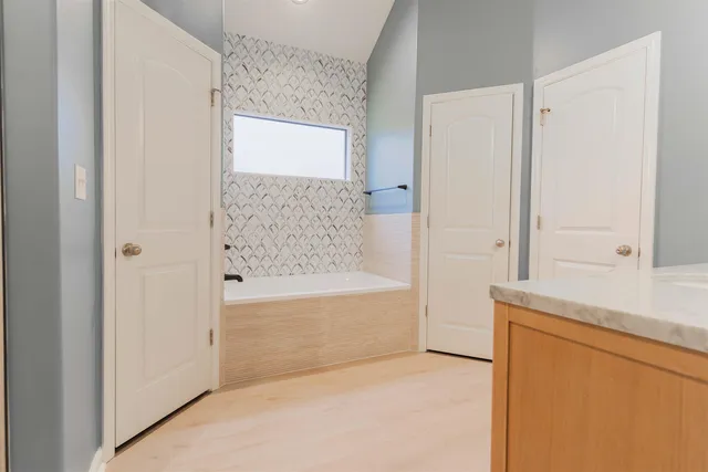 a bathroom with a bathtub and a shower
