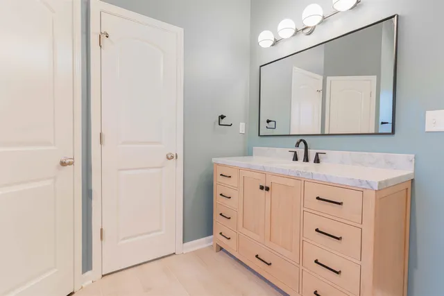 a bathroom with a double vanity sink mirror and