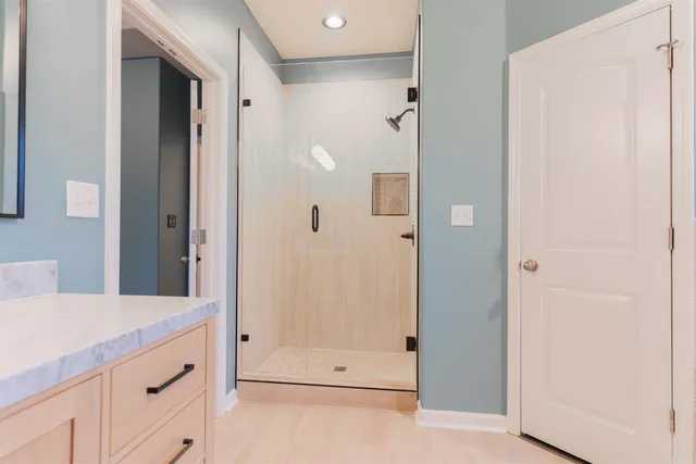 a bathroom with a shower and a sink