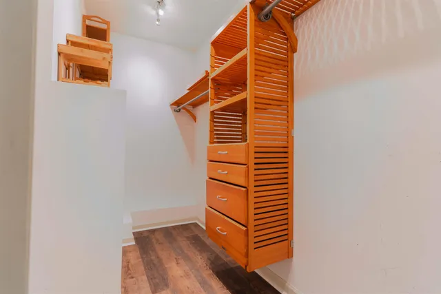 a view of walk in closet with clothes