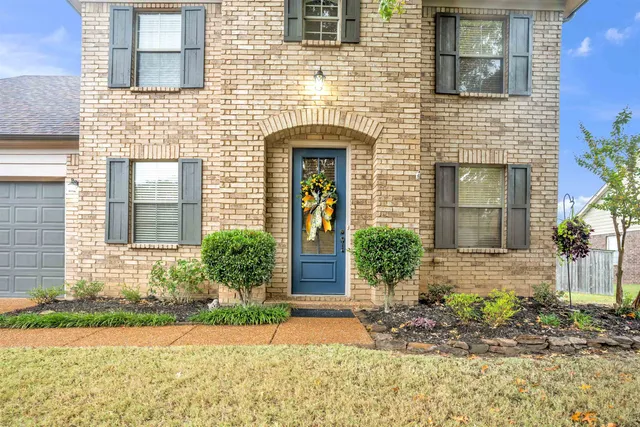 a front view of a house with garden