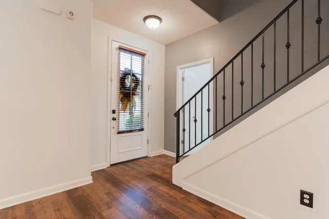 a view of an entryway with wooden floor