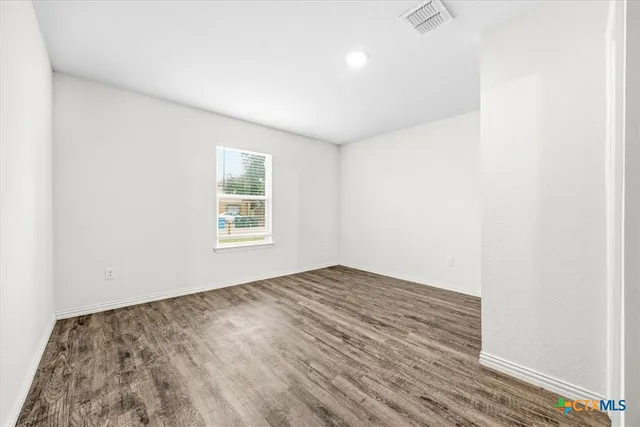 a bathroom with a granite countertop sink and toilet