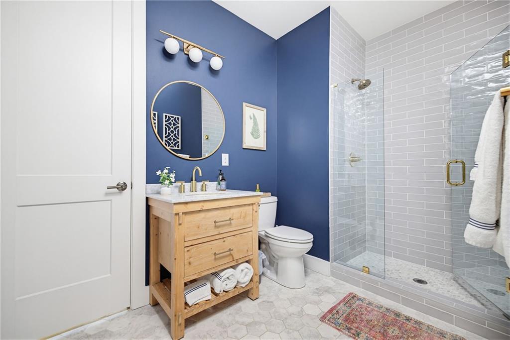 115 South Columbia Drive Decatur, GA 30030 - Photo 15 of 36 a bathroom with a toilet a sink a mirror and shower