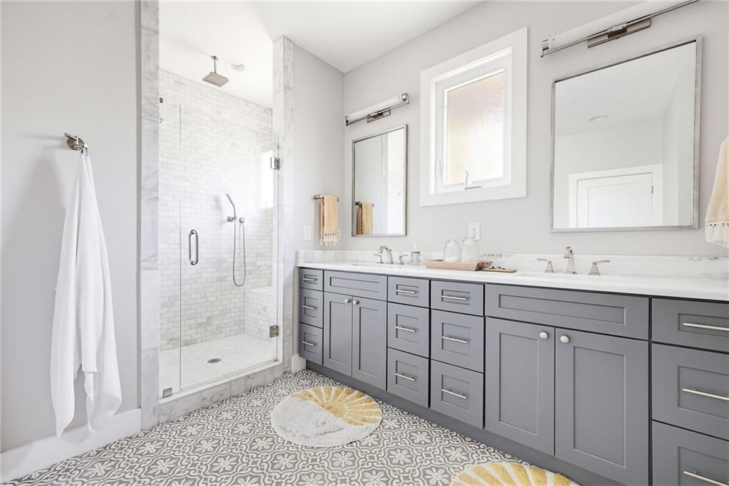 115 South Columbia Drive Decatur, GA 30030 - Photo 18 of 36 a bathroom with a granite countertop sink mirror and shower