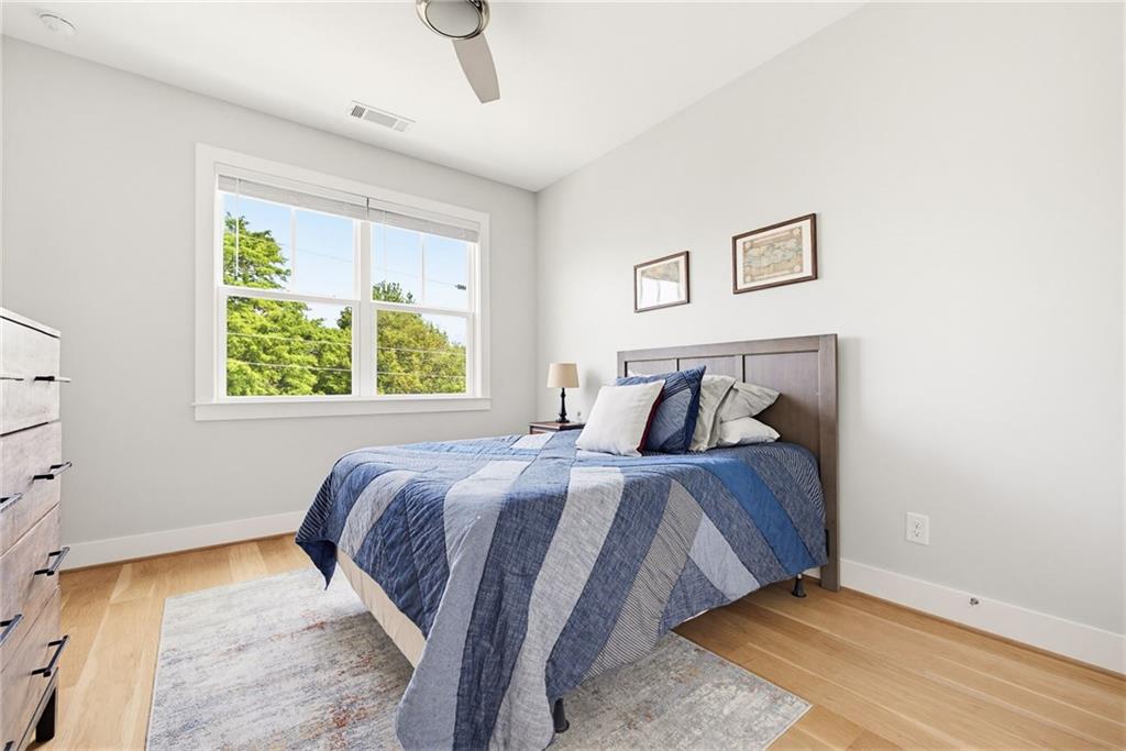 115 South Columbia Drive Decatur, GA 30030 - Photo 24 of 36 a bed sitting in a bedroom next to a window