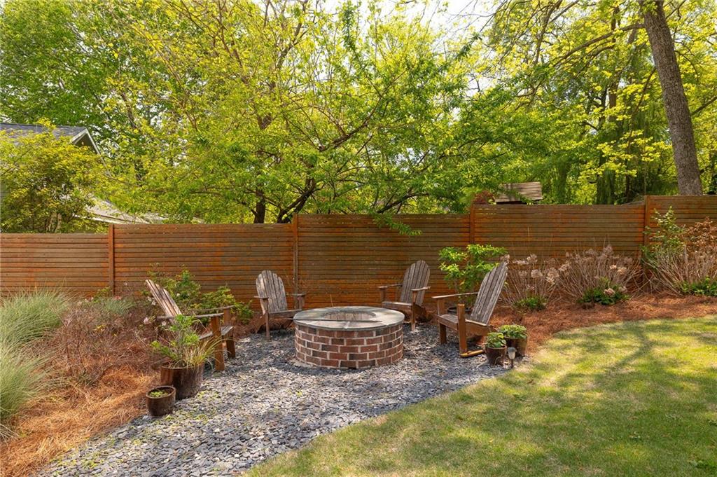 115 South Columbia Drive Decatur, GA 30030 - Photo 32 of 36 a view of a lake with a table and chairs under an umbrella