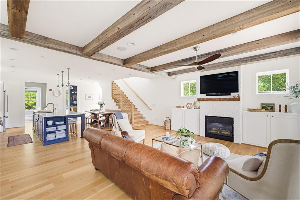 115 South Columbia Drive Decatur, GA 30030 - Photo 7 of 36 a living room with furniture a fireplace and a flat screen tv