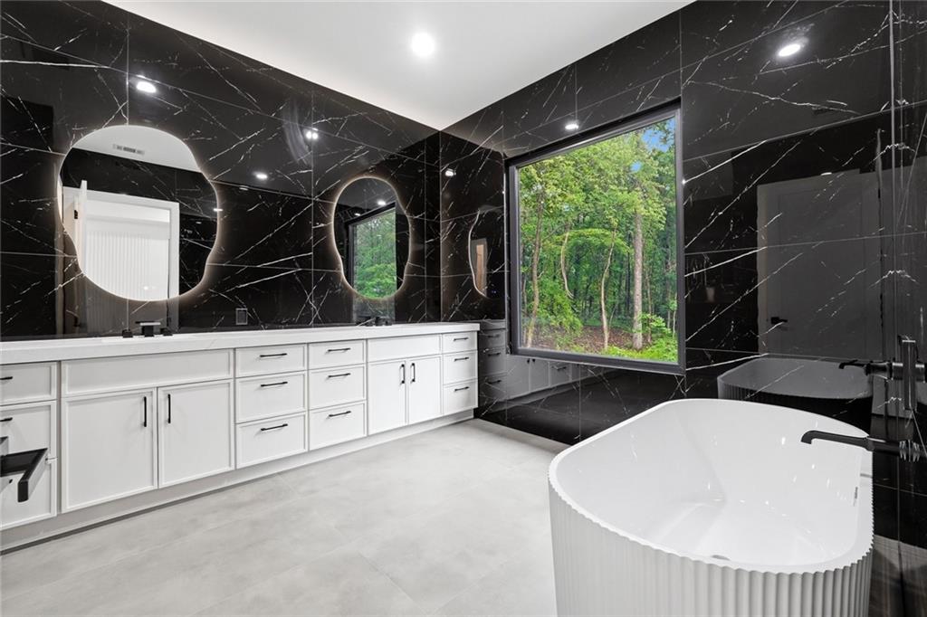 1563 Whitley Road Dacula, GA 30019 - Photo 18 of 44 a bathroom with a double vanity sink a mirror and window