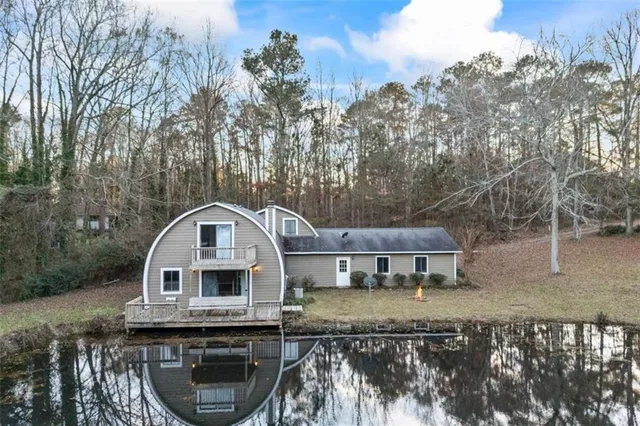 a kitchen with stainless steel appliances kitchen island granite countertop a refrigerator a stove and a sink
