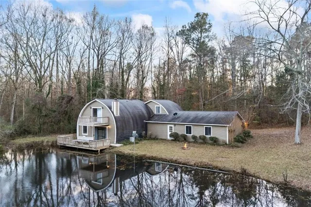 a view of a house with backyard and sitting area
