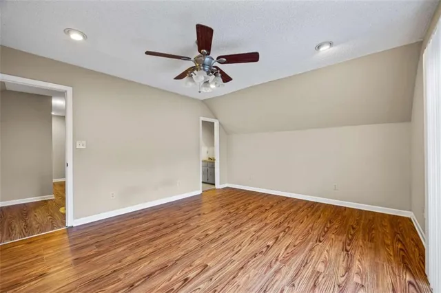 a spacious bathroom with a granite countertop sink and a mirror