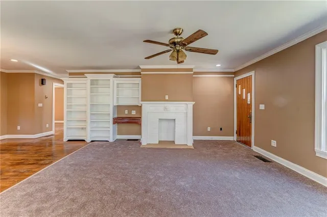 a view of empty room with wooden floor and window