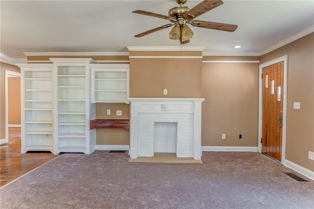 2501 Maple Road Southeast Rome, GA 30161 - Photo 16 of 56 a view of an empty room with a fireplace and a window