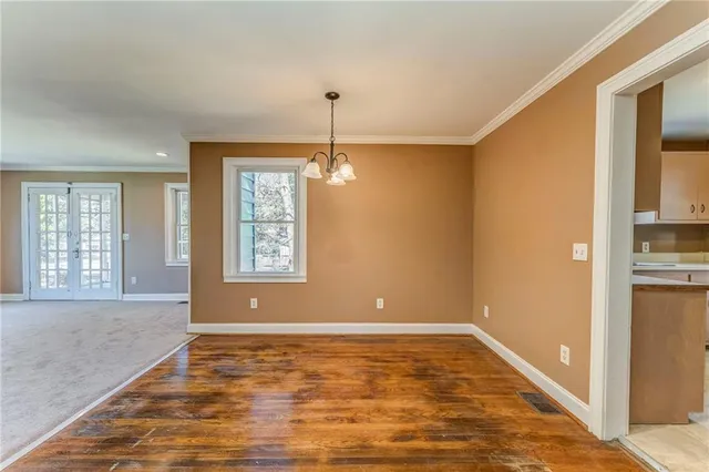 a kitchen with cabinets stainless steel appliances a sink and a window