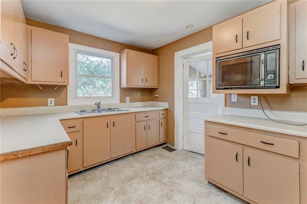 2501 Maple Road Southeast Rome, GA 30161 - Photo 20 of 56 a kitchen with cabinets stainless steel appliances a sink and a window