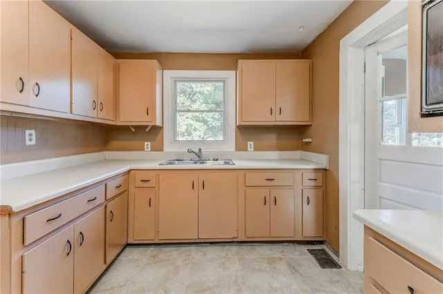 a kitchen with stainless steel appliances white cabinets and a sink