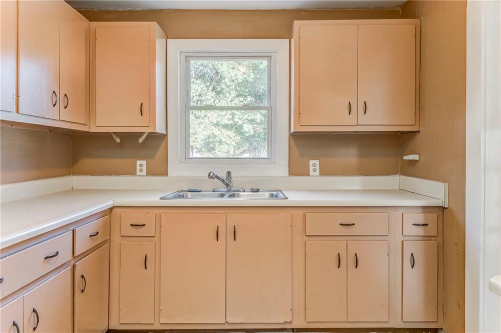 2501 Maple Road Southeast Rome, GA 30161 - Photo 22 of 56 a kitchen with granite countertop white cabinets and a sink